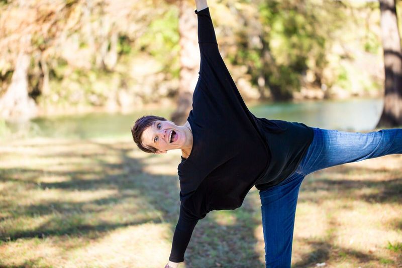 Tara mid-cartwheel by the river